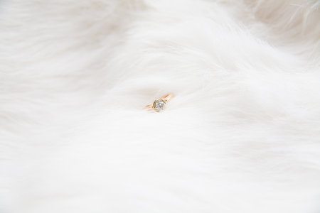 beautiful gold ring on the bride's white coatの写真素材