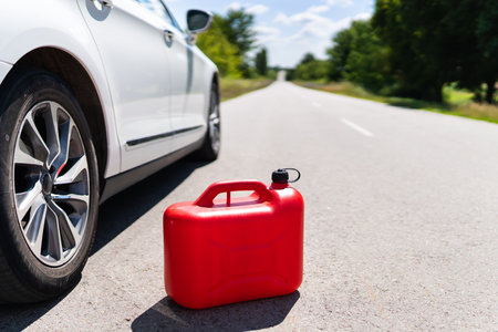 Empty car tank from a red canister on the side of the road. fuel problemの写真素材