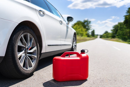 Empty car tank from a red canister on the side of the road. fuel problem. Place for an inscriptionの写真素材