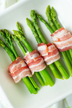 Green asparagus baked with bacon and spices. Very tasty and healthy food. view from above. vertical photoの写真素材