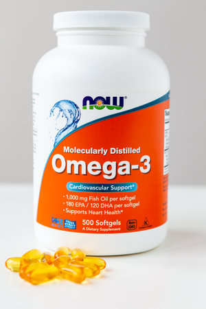 Kyiv, Ukraine - 27 January 2022: Now Foods Omega-3 natural fish oil concentrate - purified at the molecular level. Jar with omega capsules for cardiovascular support from Natural Organic Wholesomeのeditorial素材
