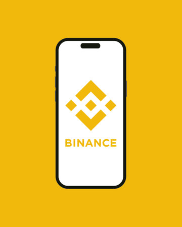 Kyiv, Ukraine - 07 June 2023: Binance cryptocurrency exchange app on the smartphone iPhone 14 screen with yellow background. Mobile app running at smartphone screen with Binance . isolated vectorのeditorial素材