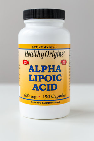 Kyiv, Ukraine - 27 January 2022: Jar with capsules Alpha Lipoic Acid from Healthy Origins. ALA pills is an organosulfur compound is made in animals normally, and is essential for aerobic metabolismのeditorial素材