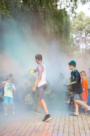 Lviv, Ukraine - July 18, 2021: Color Holi Festival, a crowd of people adults and small children throw colorful paint. Indian holidayのeditorial素材
