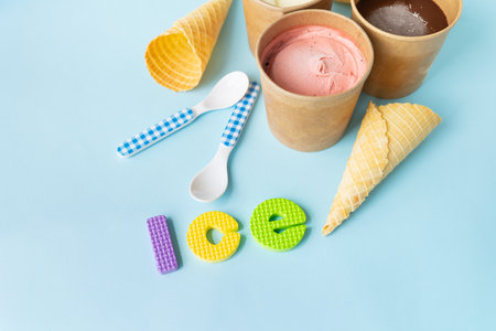 Ice cream in a box with different flavors - strawberry, chocolate, vanilla stands on a blue...
