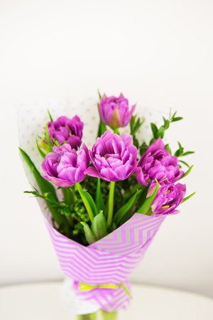 bouquet of beautiful violet lush tulips in a vase.の写真素材