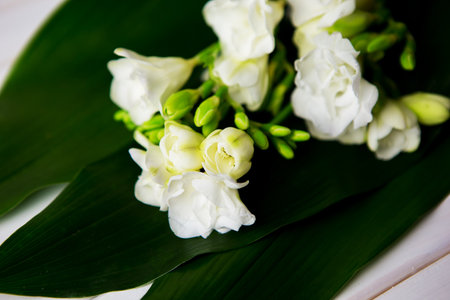 beautiful composition, a bouquet of freesia on a wooden table, close-up.の写真素材