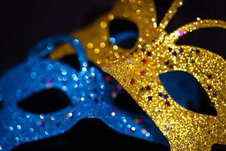 Luxurious Venetian shiny masks on a dark background. Carnival masquerade fantasy mask. Holiday and party concept. Blurred photoの写真素材