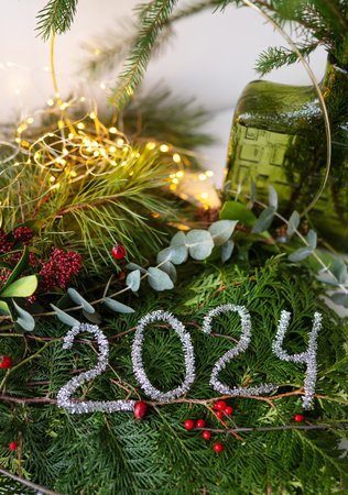 2024 new year green background from live leaves and branches. Seasonal packaging and New Year's paraphernalia. New Year's composition, a ready-made openingの写真素材