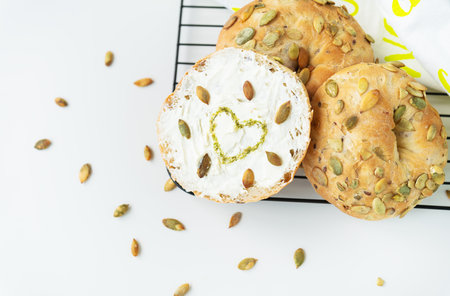 Sandwich, toast, Philadelphia cheese bagel, sunflower seeds and painted pesto heartの写真素材