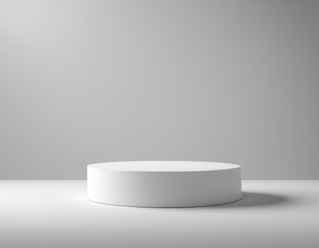 A white cylinder podium for product presentation on a white background, casting a shadowの素材