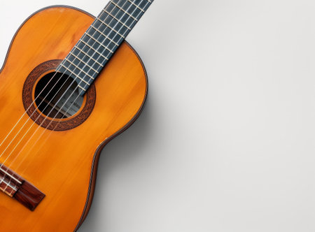 Top view of a classic wooden guitar on a white background, showcasing the instrument s curves and stringsの素材