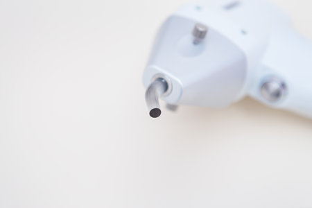 Close-up of a white laser hair removal machine isolated on a light backgroundの写真素材