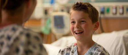 A boy's bright smile and lively conversation in a hospital bed highlight the enduring optimism that characterizes childhoodの素材