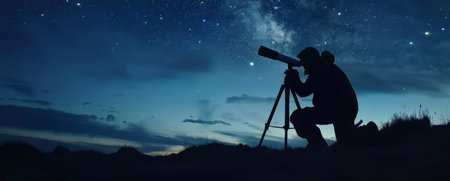 Silhouette of an amateur astronomer using a telescope to explore the starry night sky. Concept of discovery, astronomy, and scienceの素材