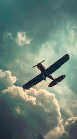 An antique biplane aircraft soars confidently through brooding, turbulent skies filled with ominous storm clouds that add an air of adventure and wonder to the sceneの素材
