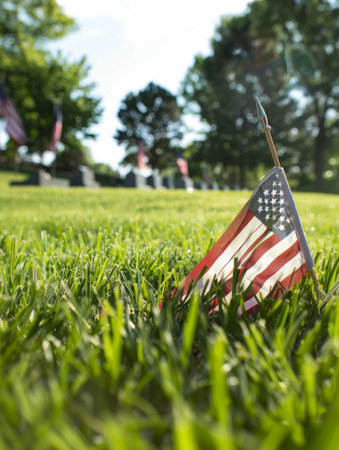 Rows of American flags adorn a lush, peaceful graveyard, honoring the memories and legacies of the fallen soldiers who served the countryの素材
