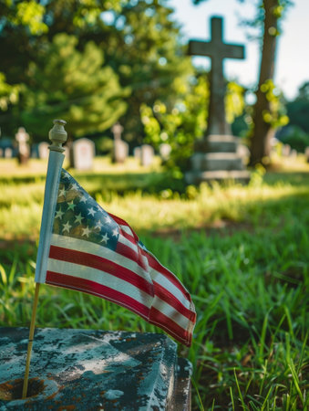 A simple but powerful Christian cross stands among the graves in a memorial garden, symbolizing the faith and service of fallen veteransの素材