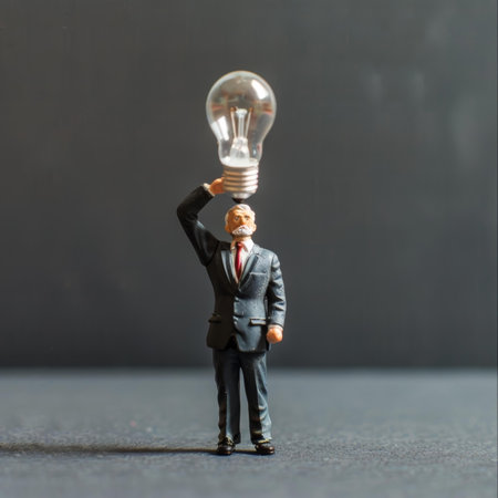 Smart businessman holding a light bulb thinking about idea, innovation, creativity for business success. Miniature entrepreneur with creative imagination for solution to solve problem or brainstormの素材