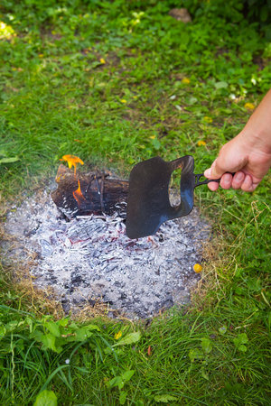 Burning fire in the evening, summer beautiful warm evening. The process of lighting a fireの写真素材