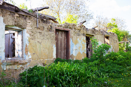 Old abandoned one-story house in disrepair. Collapsed walls and roofsの写真素材