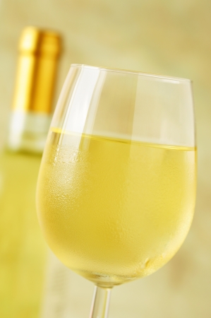 Close-up of a ice cold glass of white wine covered with water drops - condensationの写真素材