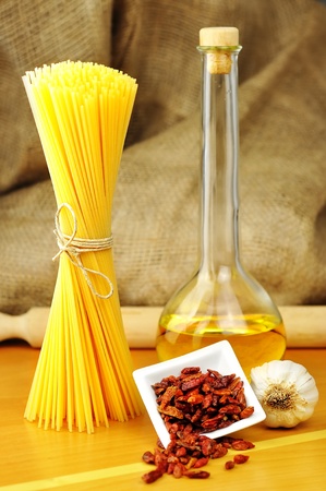 Raw ingredients for spaghetti aglio, olio e peperoncino  garlic, oil, and chili , selective focusの写真素材