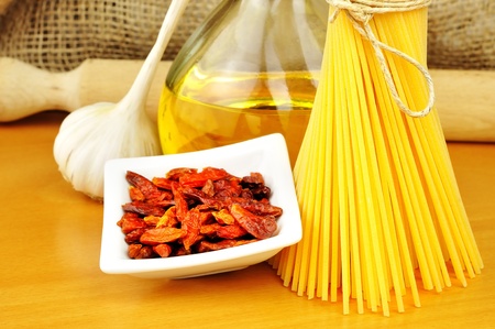 Raw ingredients for spaghetti aglio, olio e peperoncino  garlic, oil, and chili , selective focusの写真素材