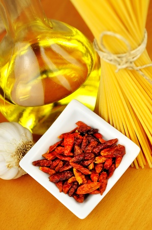 Raw ingredients for spaghetti aglio, olio e peperoncino  garlic, oil, and chili , selective focusの写真素材