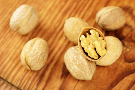 Walnuts on a old wooden table, selective focus