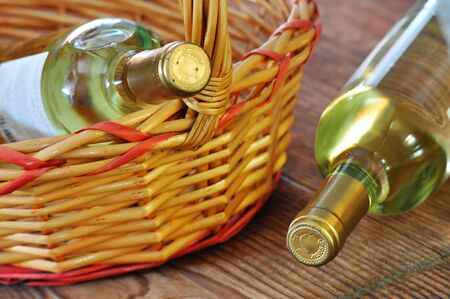 Two bottles of fine italian white wine in a basketの写真素材