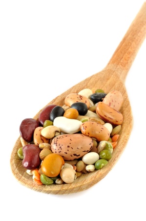 Pulses soup mixture on a wooden spoon, isolated on whiteの写真素材