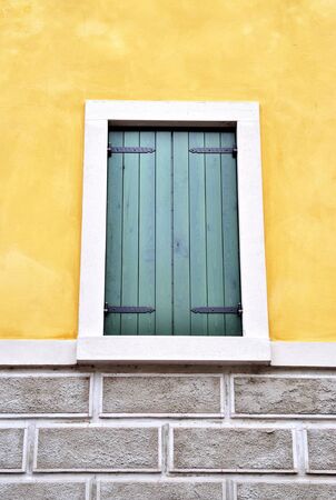 Vintage window on yellow wallの写真素材