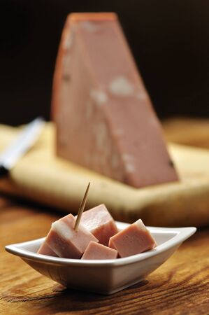 Fresh mortadella on a wooden chopping board, italian foodの写真素材