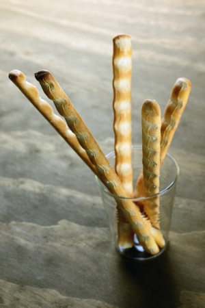 Grissini, italian bread sticks on a old wooden table, selective focus