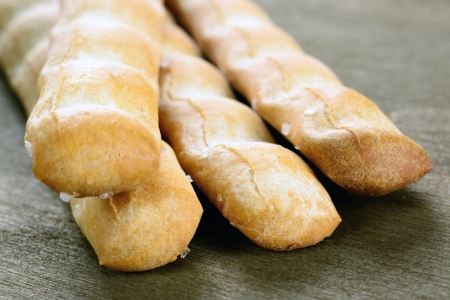 Grissini, italian bread sticks on a old wooden table, selective focus
