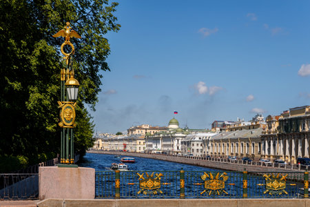 The Fontanka River in Petersburg with pleasure boats, a decorated lantern, and historical buildings on the embankment.の写真素材