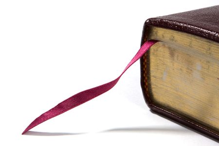 Bible corner with fuchsia colored bookmark and gold edged pages. Room for copy on left.