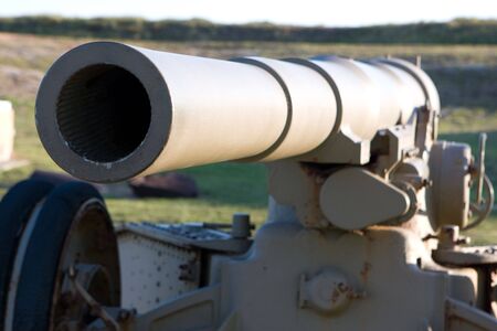 Old barrel of an artillery piece of World War 1 era sits idle.