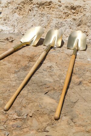 Gold shovels lay at a construction site after a ground breaking ceremony.の写真素材