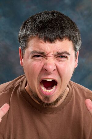 Suffering man show the emotion on his face.の写真素材