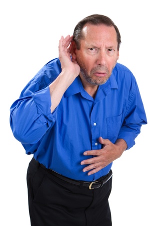Senile senior adult male cups his hand to the ear because of a loss of hearing problem.の写真素材