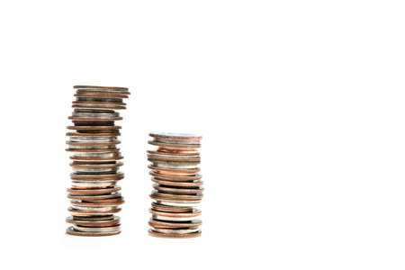 Two stacks of coins against white for use in financial and banking concepts.