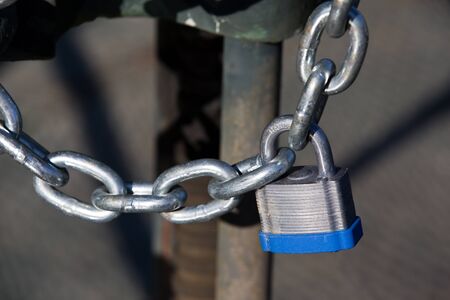 Chained and padlocked gate is used as security and protection concept.