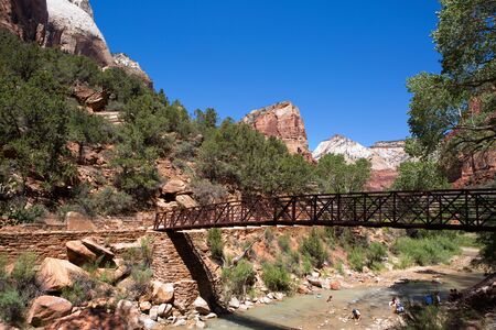 SPRINGDALE, UTAH - AUGUST 17, 2015: Tourists cool off in the Virgin River as it runs through the valley in Zion National Park, Springdale, Utah, USA, on August 17, 2015.のeditorial素材