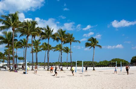MIAMI BEACH, FLORIDA - FEBRUARY 15, 2017: Group of men play a friendly game of volleyball on the sands of Miami Beach, Florida, USA on February 15, 2017.のeditorial素材