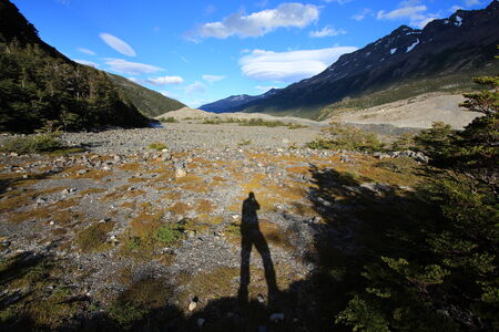 A photographer takes advantage of the evening light near glacier Los Perros in Torres del Paine National Park, Patagonia, Chile.の写真素材