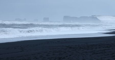 Sea stacks in the North Atlantic Ocean. Black sand beach on the coast near Vik, Iceland. Winter weather.の写真素材