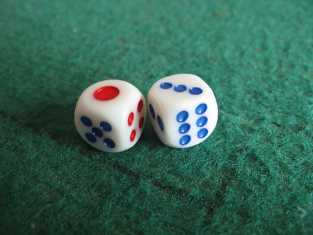 two dice on green casino gamble table