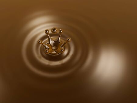 Chocolate liquid drop crown and ripple backgroundの写真素材